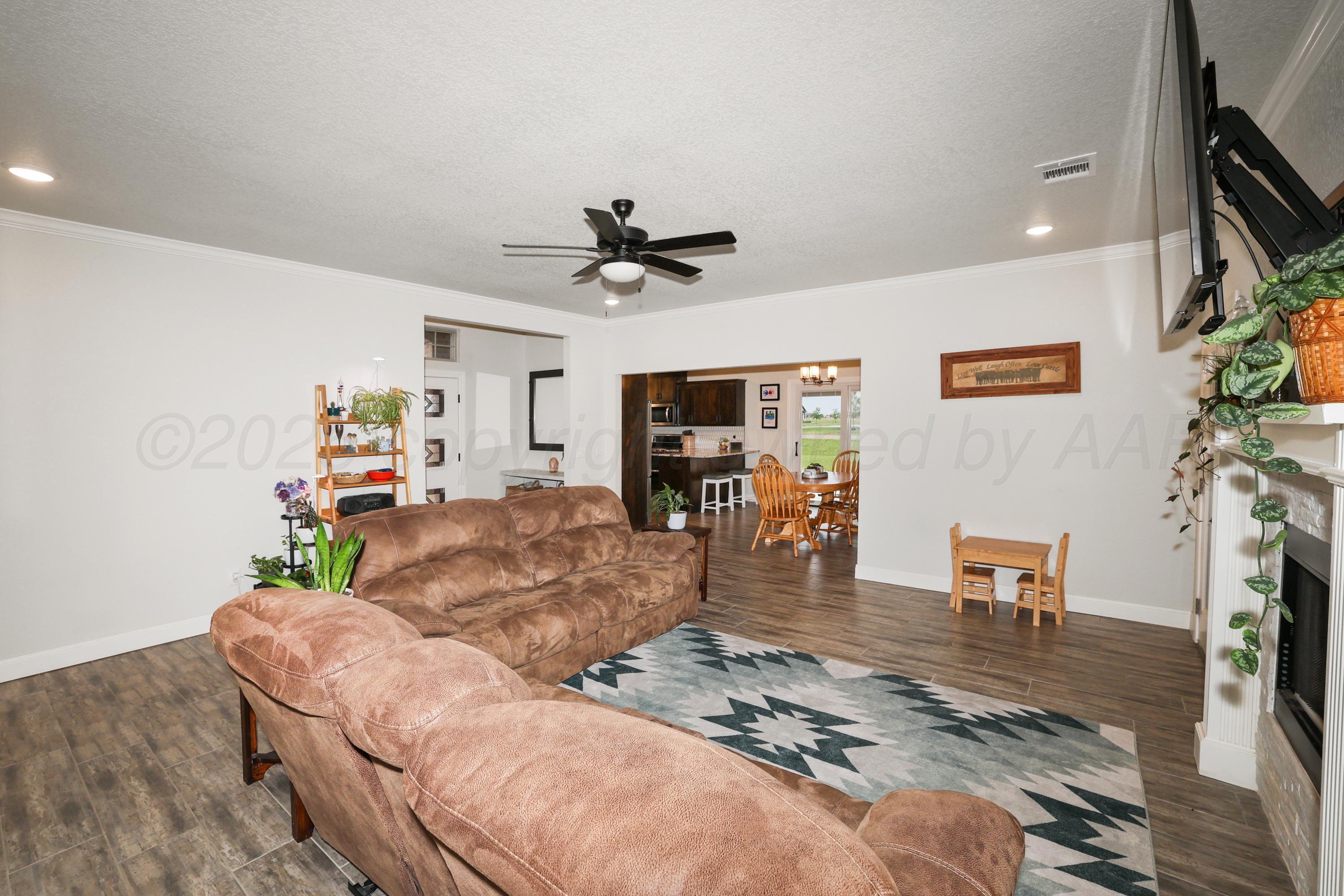 17450 Stone Creek Road Amarillo, TX 79124 - Photo 8 of 30 a living room with furniture and a flat screen tv