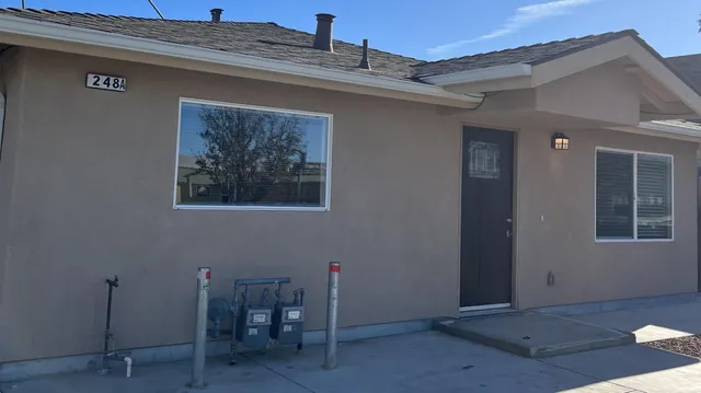 a view of a livingroom with a table and chairs
