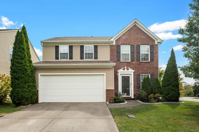 front view of a house with a yard