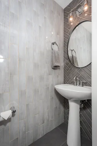 a bathroom with a sink and mirror