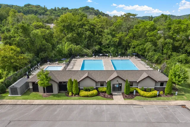 a view of a house with a yard and lake view