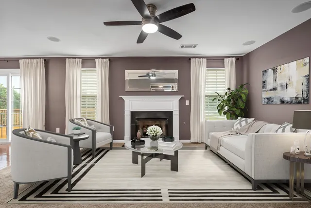 a living room with furniture and a fireplace