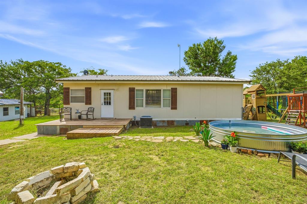 151 High Point Road Weatherford, TX 76088 - Photo 18 of 40 a view of a house with swimming pool and a yard