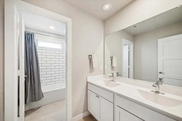 a bathroom with a sink a toilet and shower curtain