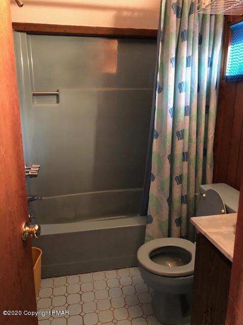 228 Haystack Road Henryville, PA 18332 - Photo 7 of 8 a bathroom with a sink a toilet and shower