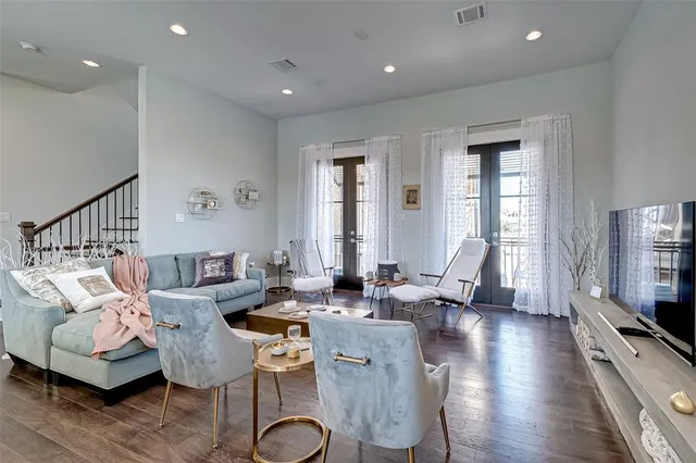 a living room with furniture and kitchen view