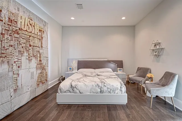 a bedroom with a large bed and a large window