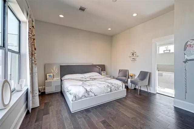 a bedroom with bed and a flat screen tv