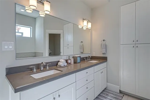 a bathroom with a double vanity sink and mirror
