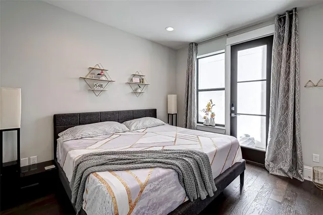 a bedroom with a bed and painting on the wall