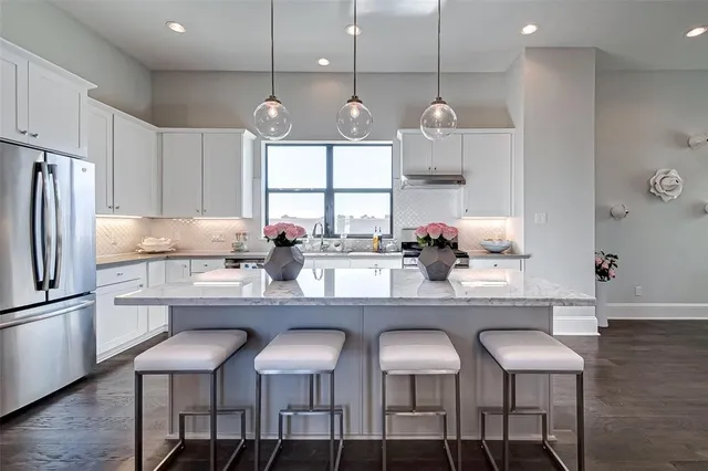 a large kitchen with a table and chairs