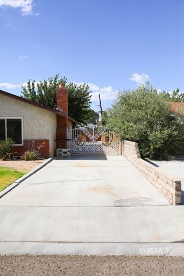 516 West Wasp Avenue Ridgecrest, CA 93555 - Photo 2 of 25 a view of a swimming pool with a yard