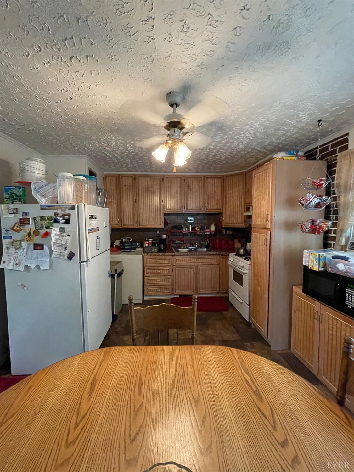 42 Pilot View Road Concord, VA 24538 - Photo 6 of 12 a kitchen with refrigerator and chairs