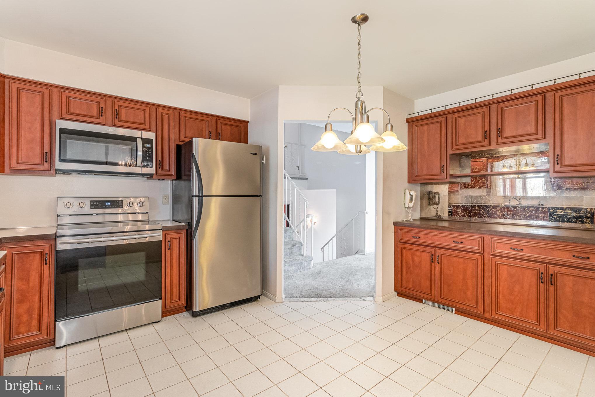 2659 Ritner Highway Carlisle, PA 17015 - Photo 7 of 40 a kitchen with stainless steel appliances granite countertop a refrigerator a stove a sink and dishwasher