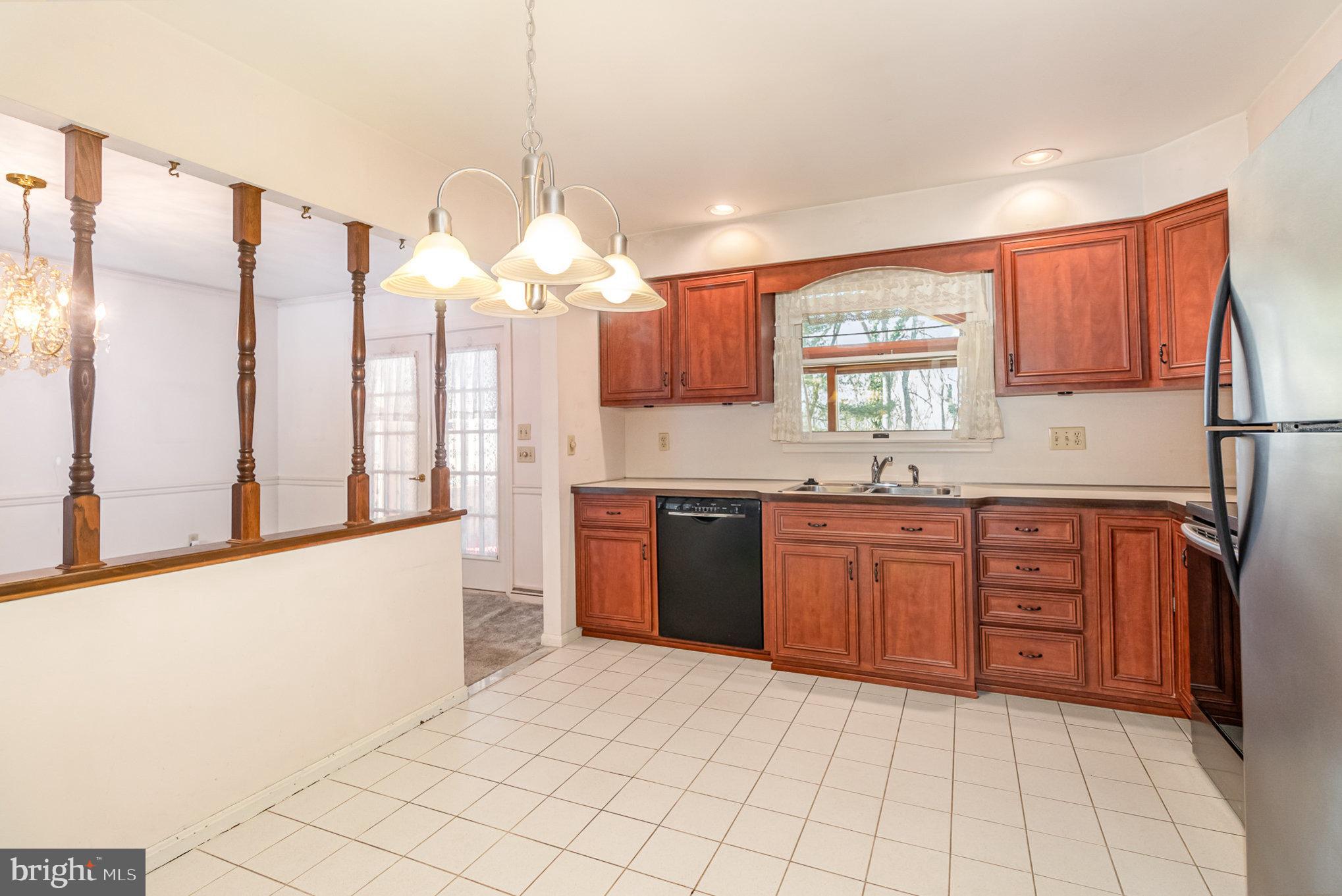 2659 Ritner Highway Carlisle, PA 17015 - Photo 8 of 40 a kitchen with stainless steel appliances granite countertop a stove a sink and a refrigerator