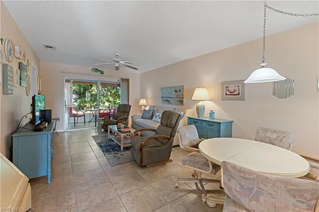 a living room with furniture a table and a chandelier