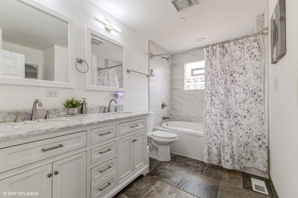 1119 Harding Avenue Calumet City, IL 60409 - Photo 7 of 11 a view of bathroom with a granite countertop sink a toilet and a shower