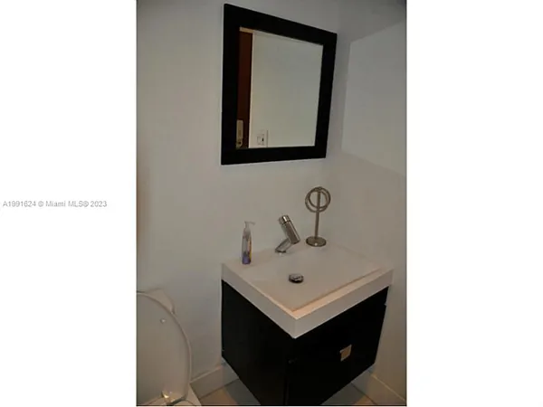 a bathroom with a sink a mirror and vanity