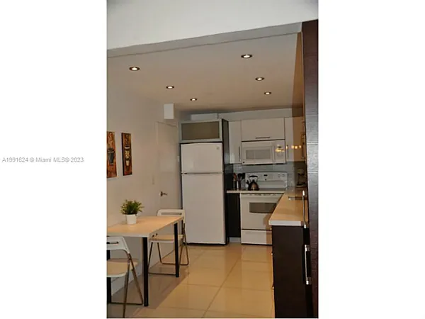 a kitchen with cabinets and stainless steel appliances