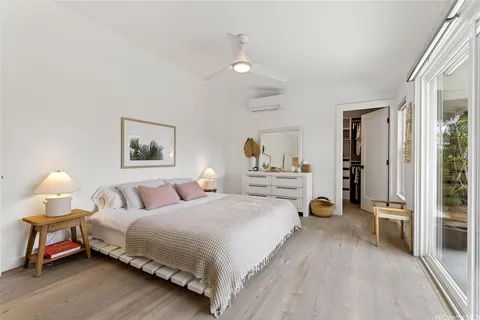 a spacious bedroom with a bed and a lamp