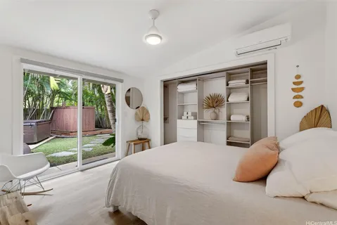 a bedroom with a bed and a large window