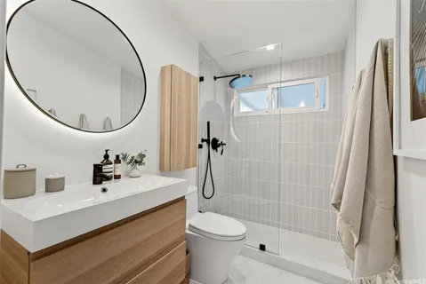 a bathroom with a sink toilet and shower