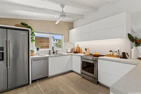 a kitchen with granite countertop stainless steel appliances and sink