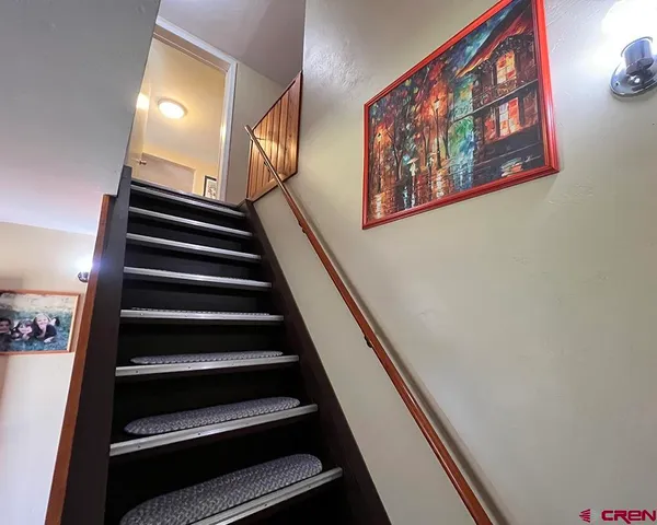 a view of staircase with wooden floor