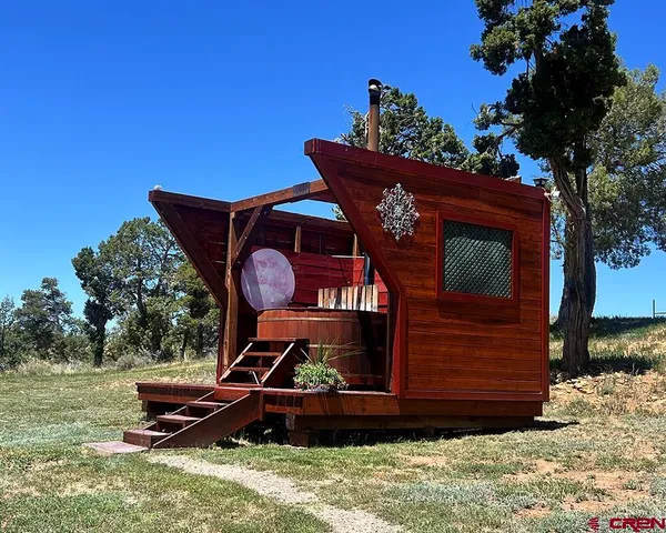 a wooden bench sitting in front of a house
