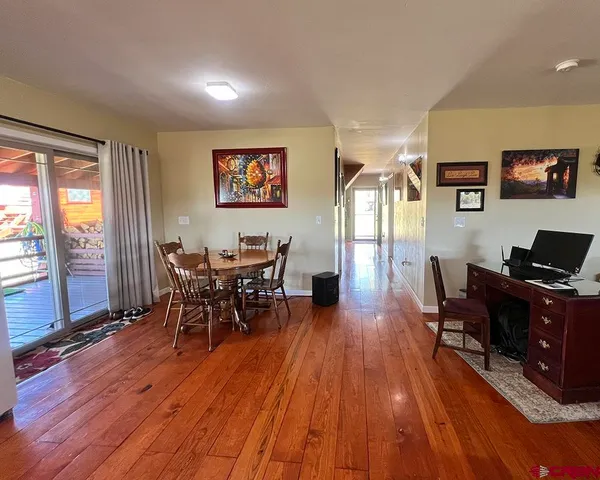 a view of a dining room with furniture window and wooden floor