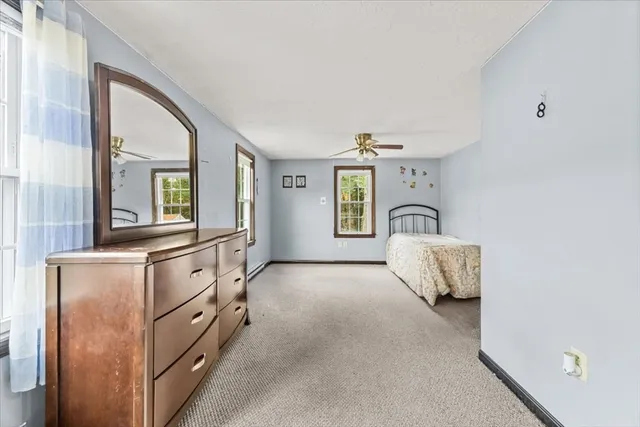 a spacious bedroom with a bed and a cabinets