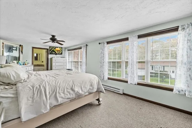 a spacious bedroom with a bed and a large window