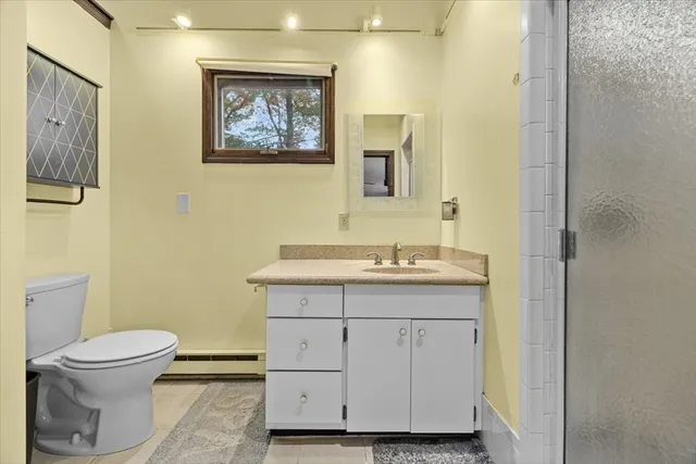 a bathroom with a toilet sink and mirror