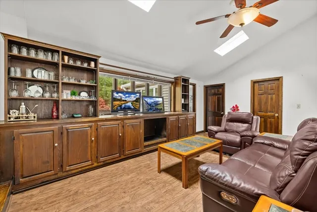 a living room with furniture a rug and a window