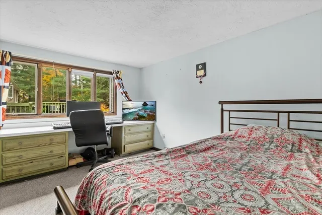 a bedroom with a bed and a large window