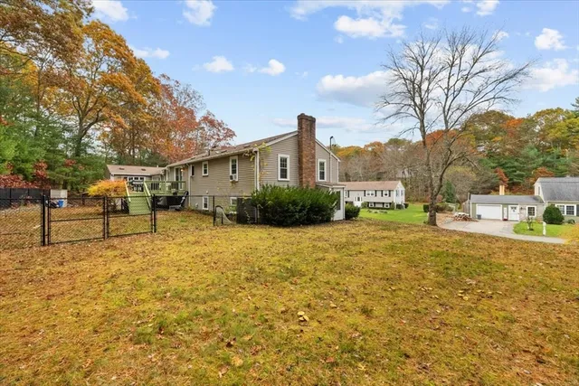 a yellow house with trees in front of it