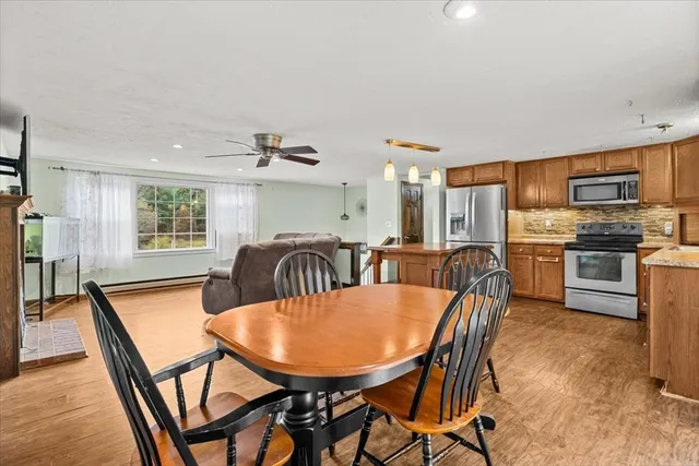 a view of a dining room with furniture and a kitchen