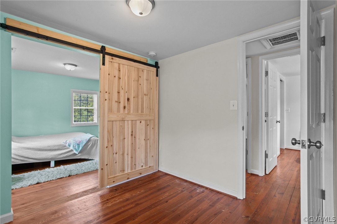 3115 Lewiston Road Bumpass, VA 23024 - Photo 33 of 43 a view of a hallway with wooden floor and furniture