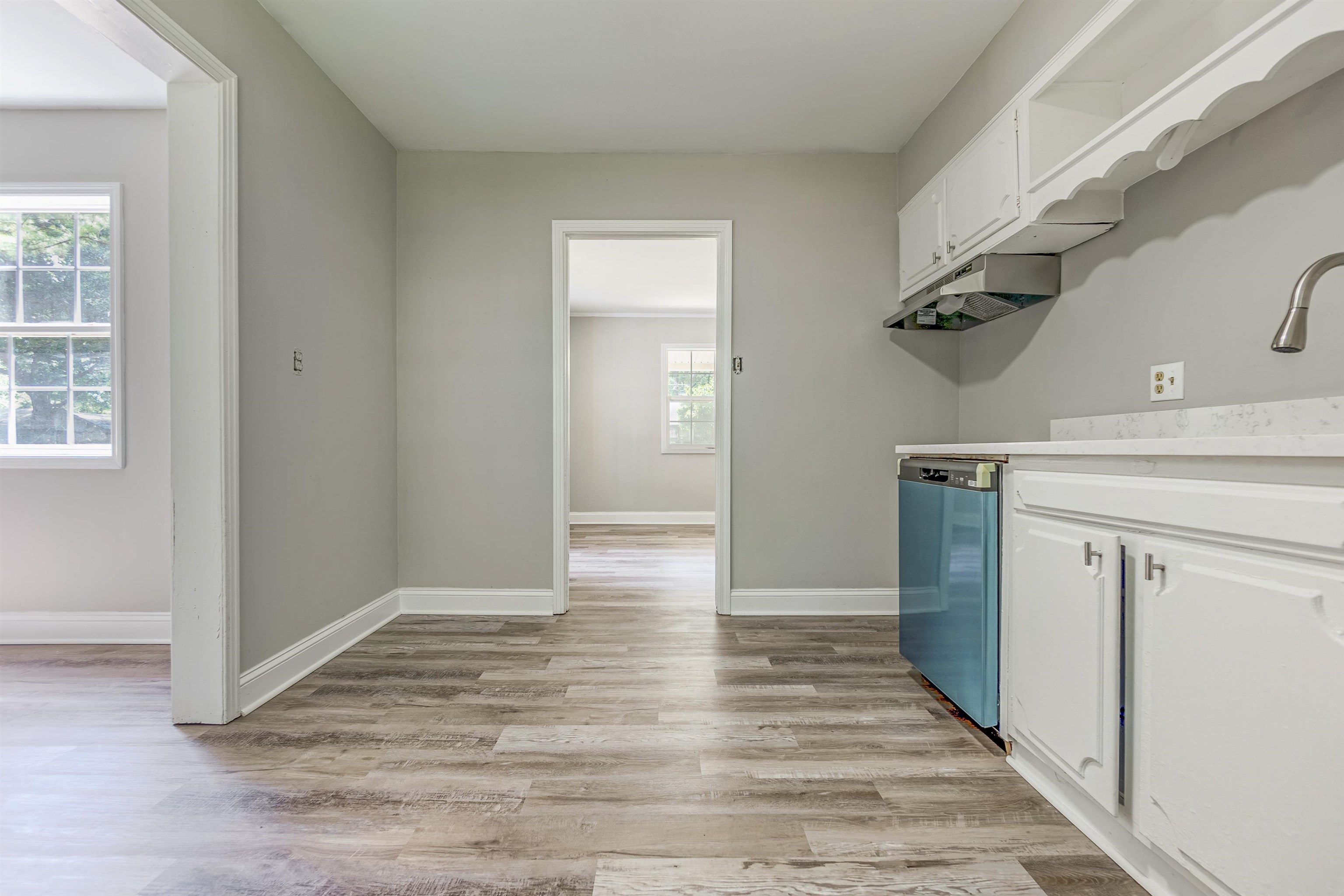 7841 Sherman Road Millington, TN 38053 - Photo 3 of 14 Kitchen with white cabinetry, dishwasher, and light hardwood / wood-style flooring