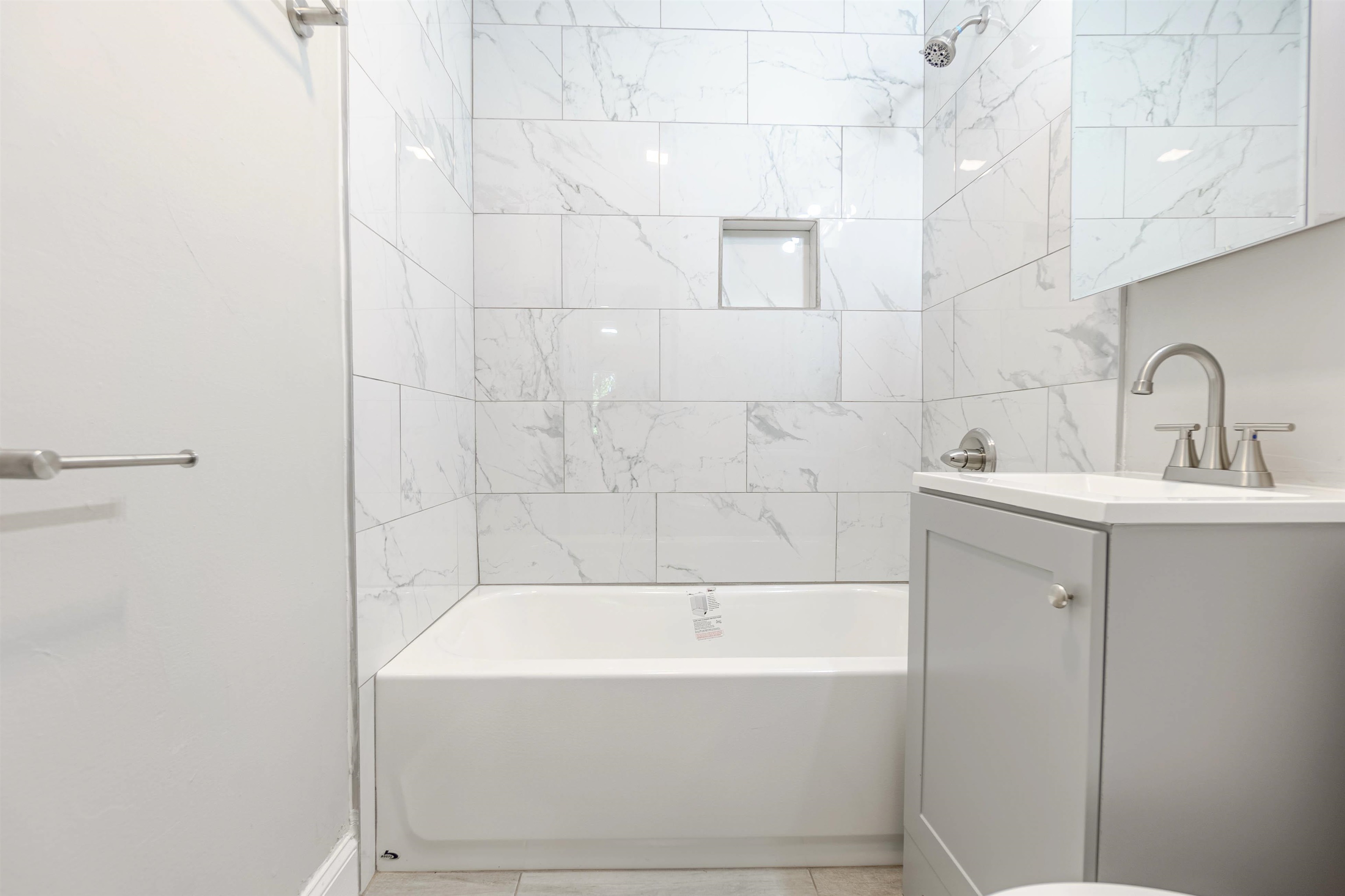 7841 Sherman Road Millington, TN 38053 - Photo 4 of 14 Full bathroom with tile flooring, tiled shower / bath combo, vanity, and toilet