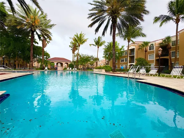 a view of swimming pool with outdoor seating and lake view