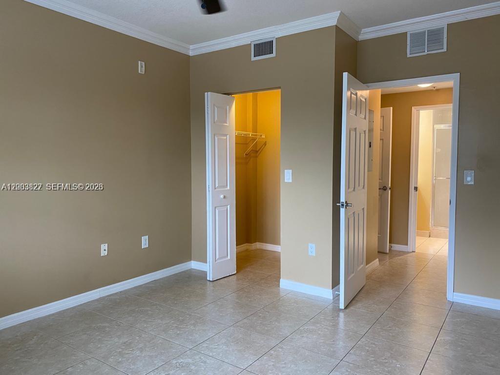 8060 North Nob Hill Road, Unit 203 Tamarac, FL 33321 - Photo 11 of 69 a view of an empty room with closet and a bathroom