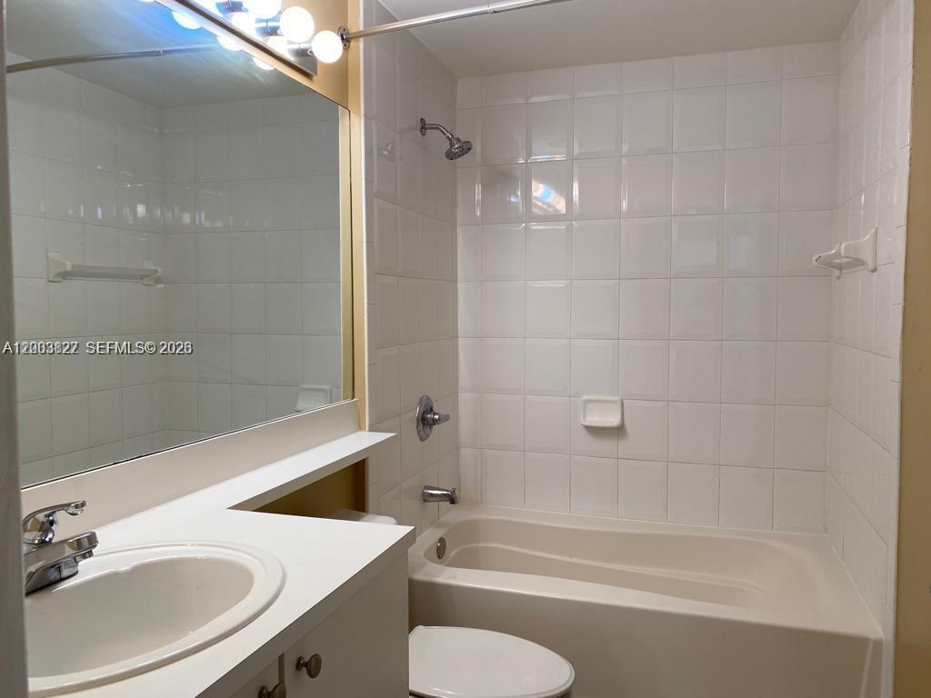 8060 North Nob Hill Road, Unit 203 Tamarac, FL 33321 - Photo 12 of 69 a bathroom with a sink a toilet and shower