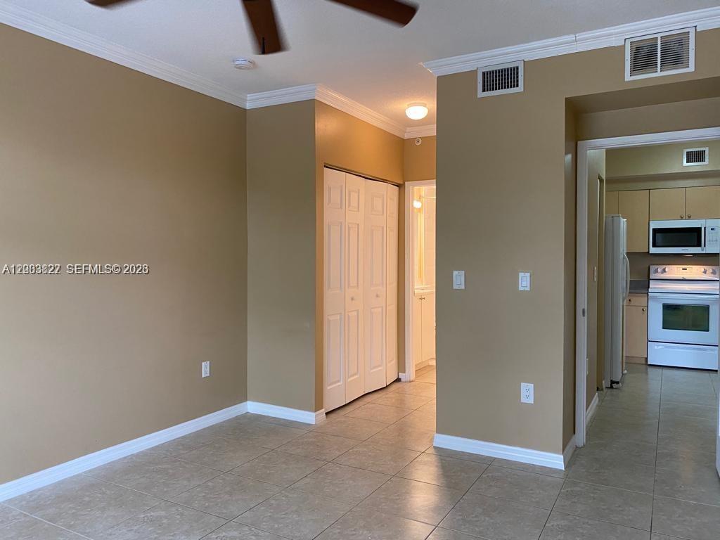 8060 North Nob Hill Road, Unit 203 Tamarac, FL 33321 - Photo 13 of 69 an empty room with closet and windows