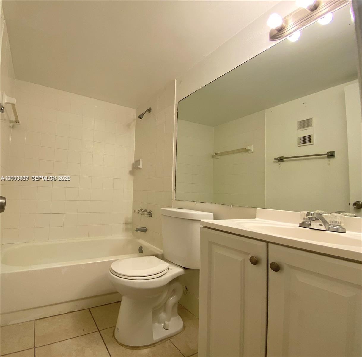 8060 North Nob Hill Road, Unit 203 Tamarac, FL 33321 - Photo 14 of 69 a bathroom with a sink toilet and shower