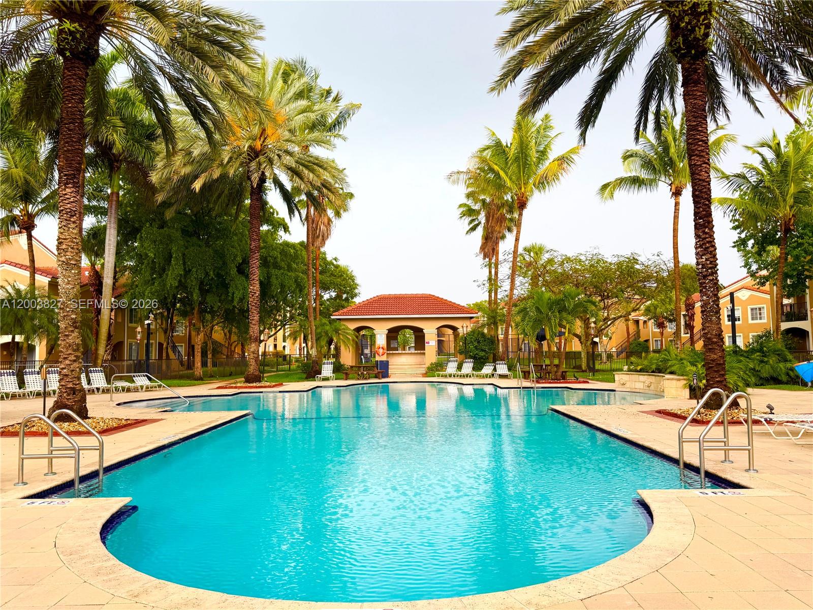 8060 North Nob Hill Road, Unit 203 Tamarac, FL 33321 - Photo 31 of 69 a view of a swimming pool with a patio