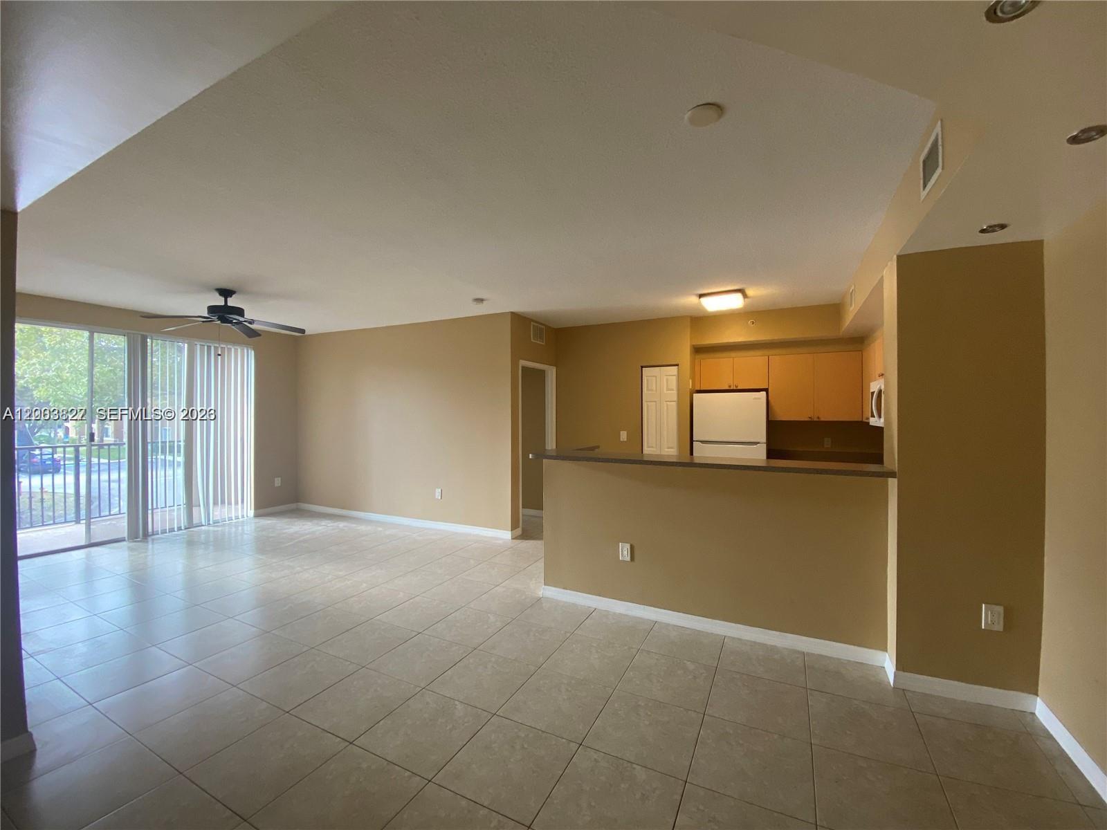8060 North Nob Hill Road, Unit 203 Tamarac, FL 33321 - Photo 4 of 69 a view of a livingroom with an empty space