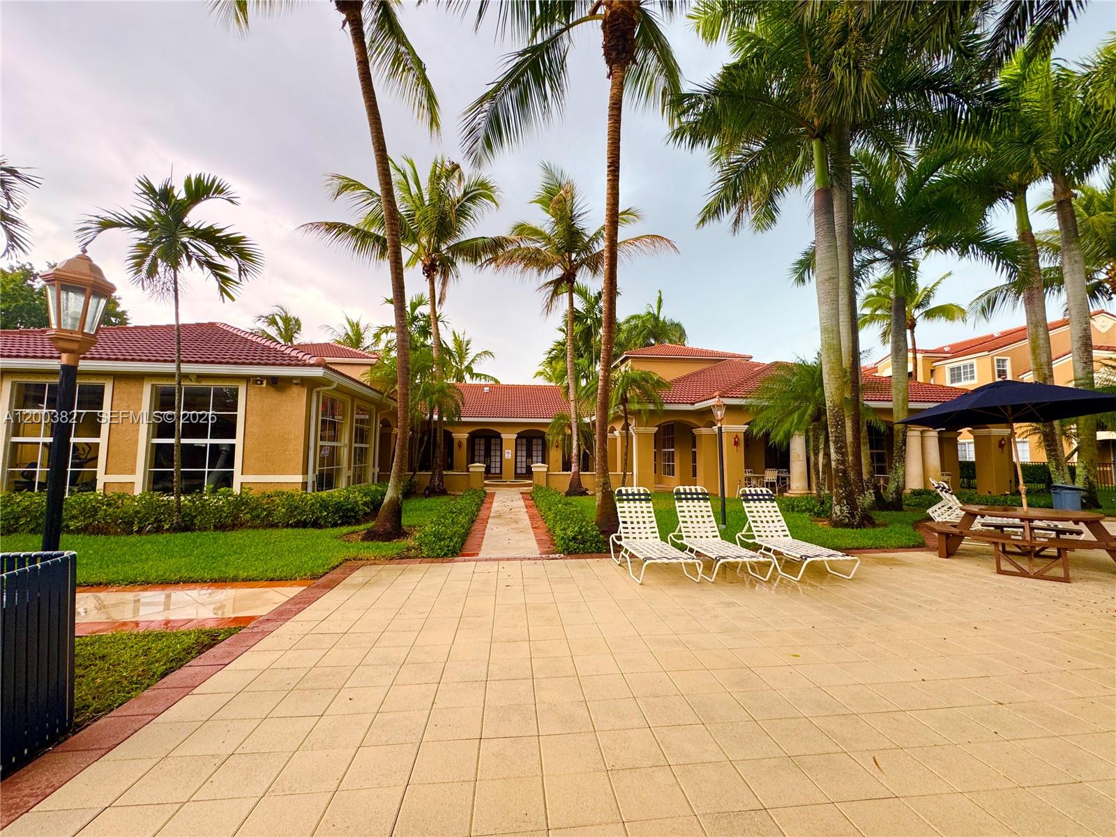 8060 North Nob Hill Road, Unit 203 Tamarac, FL 33321 - Photo 43 of 69 a view of a building with a yard and palm trees