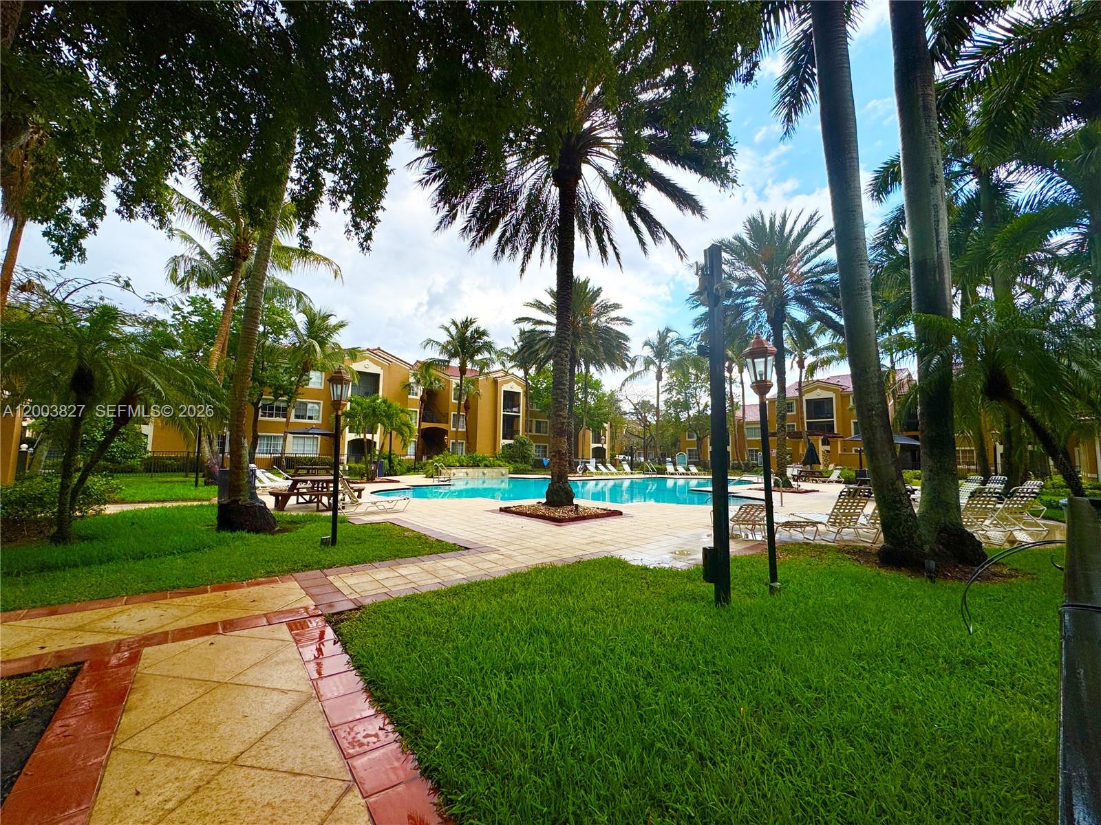 8060 North Nob Hill Road, Unit 203 Tamarac, FL 33321 - Photo 57 of 69 a view of a backyard with palm trees