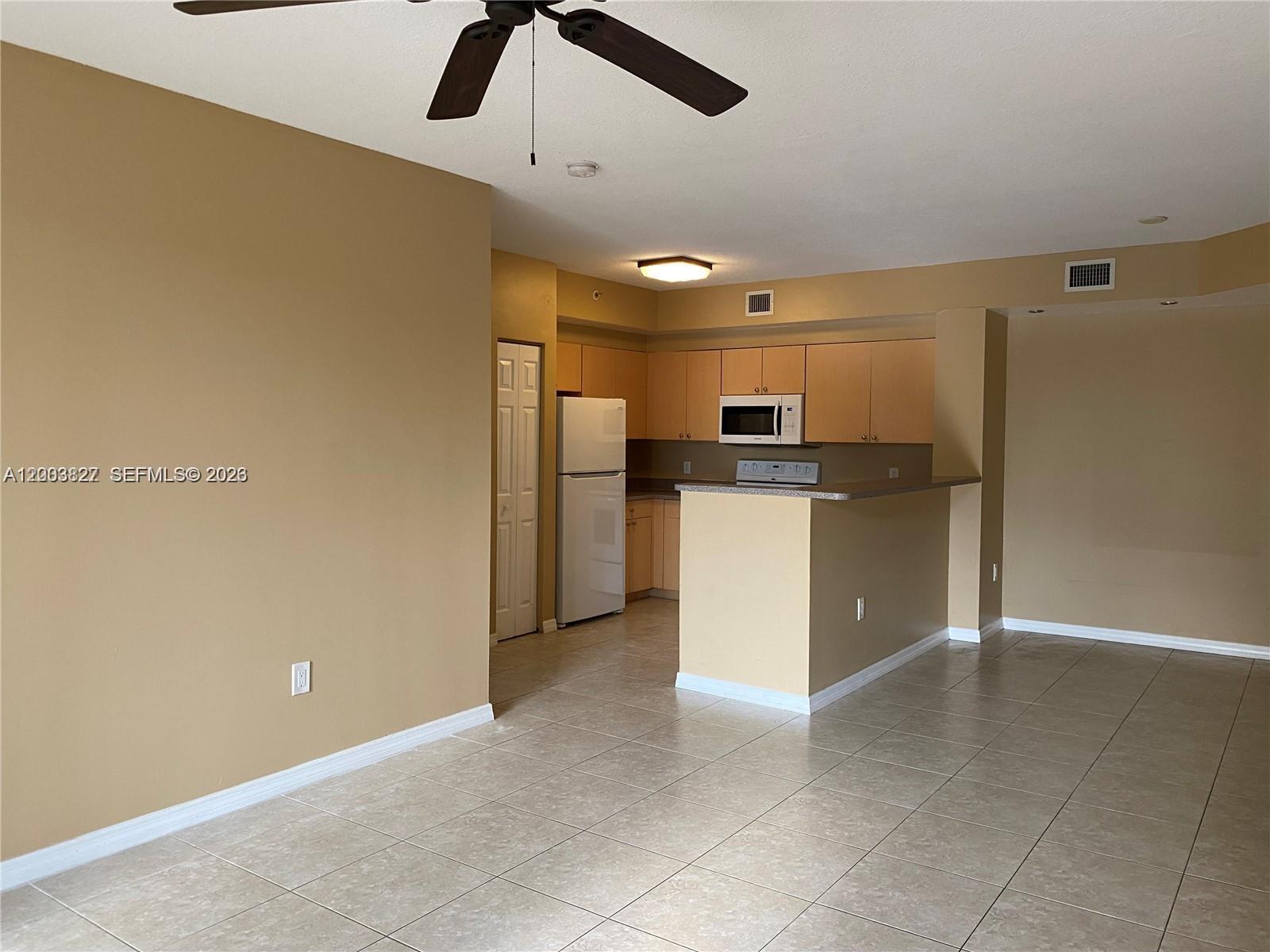 8060 North Nob Hill Road, Unit 203 Tamarac, FL 33321 - Photo 6 of 69 a view of a kitchen with a sink and stainless steel appliances